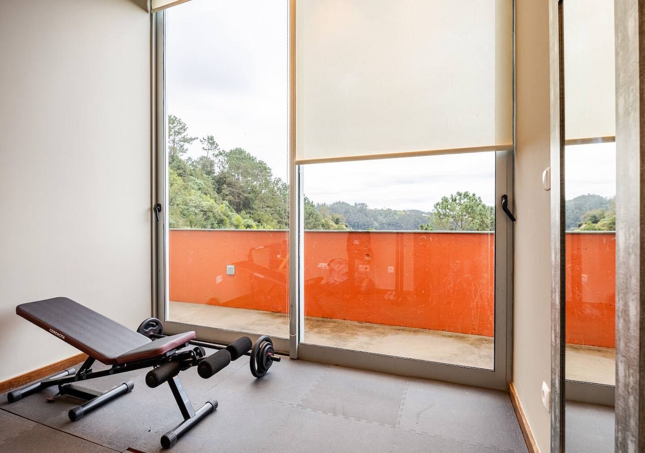 Gym bench and weights in front of the orange terrace