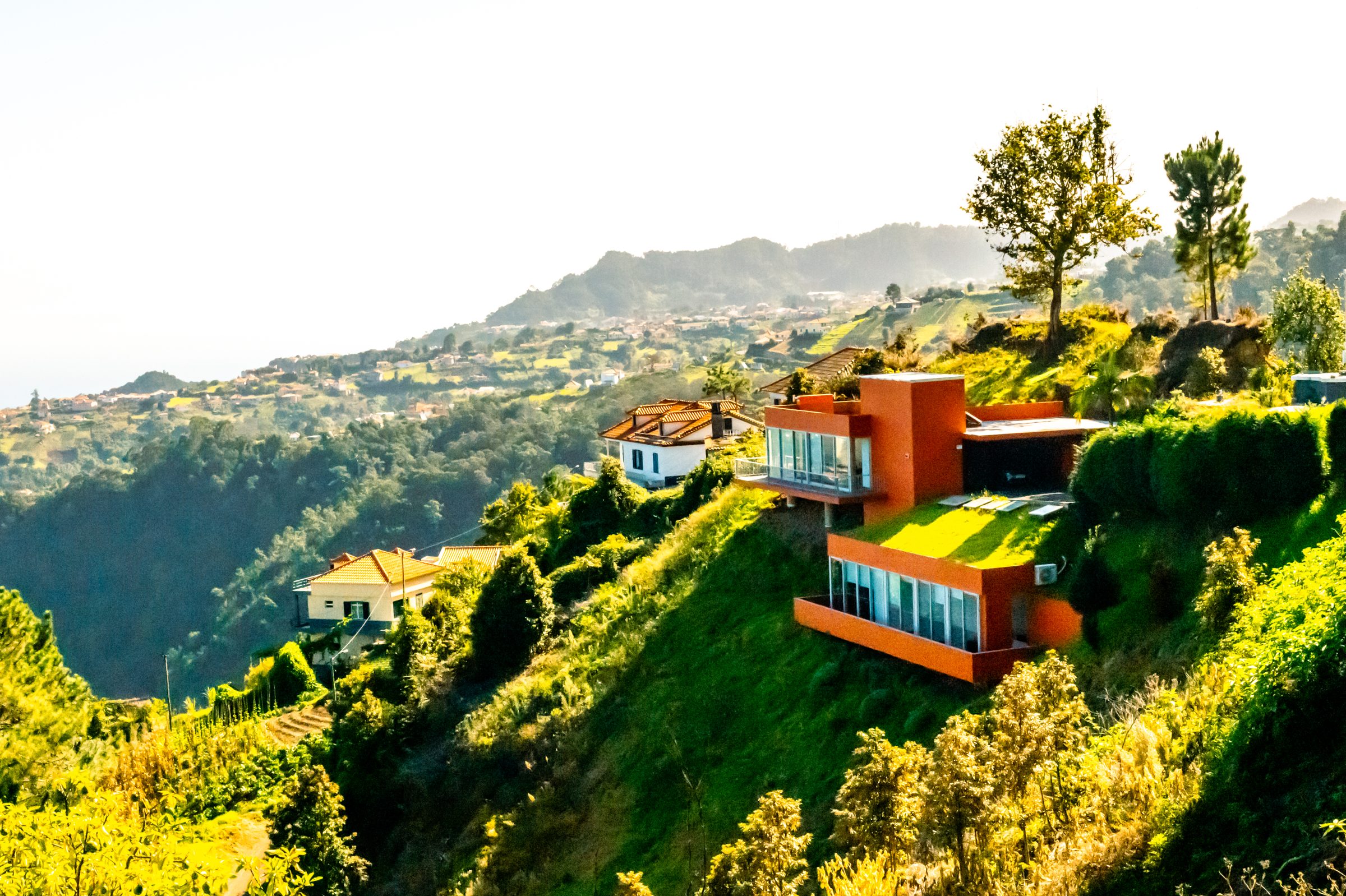 Sunny view of the orange villa terraced into a green Santana hillside