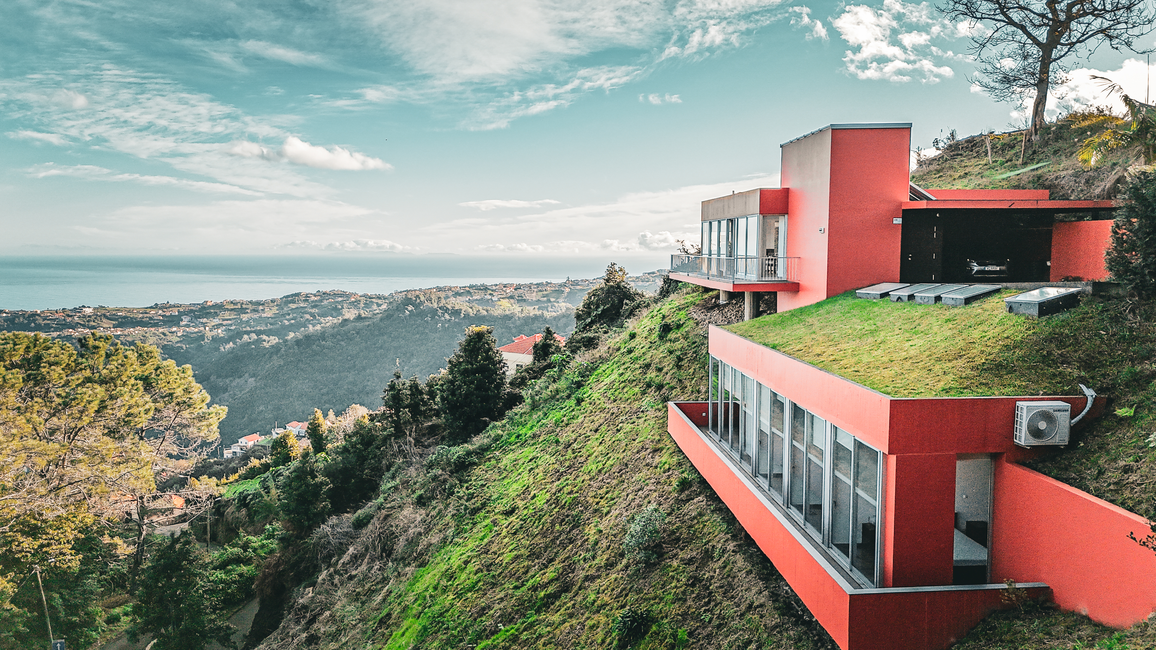 Drone view of the orange hillside villa above Santana