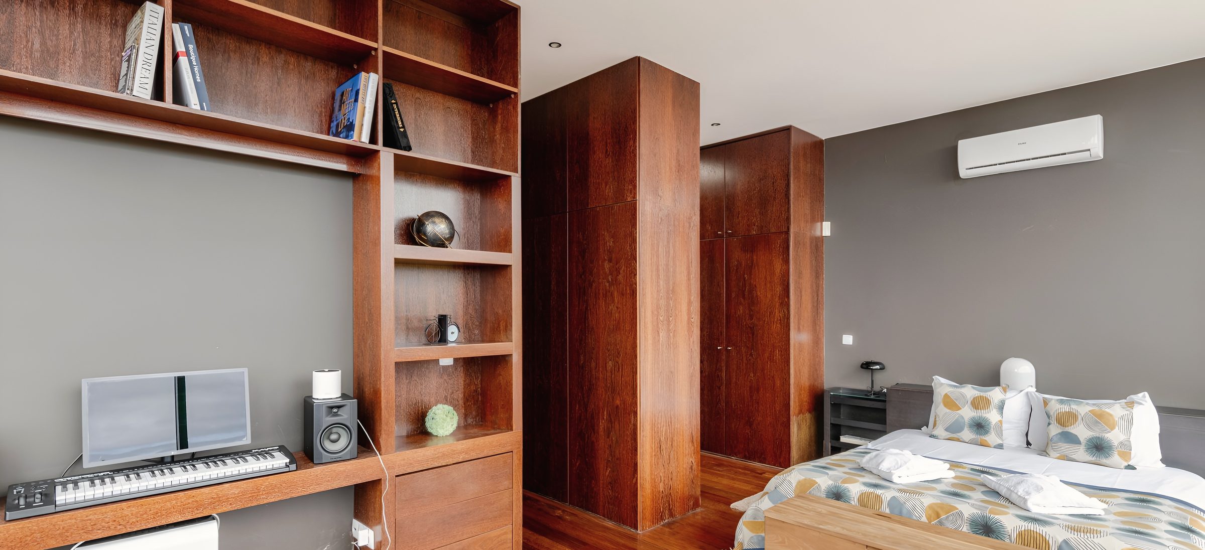 The master suite with the music desk built into the bookshelves beside the bed