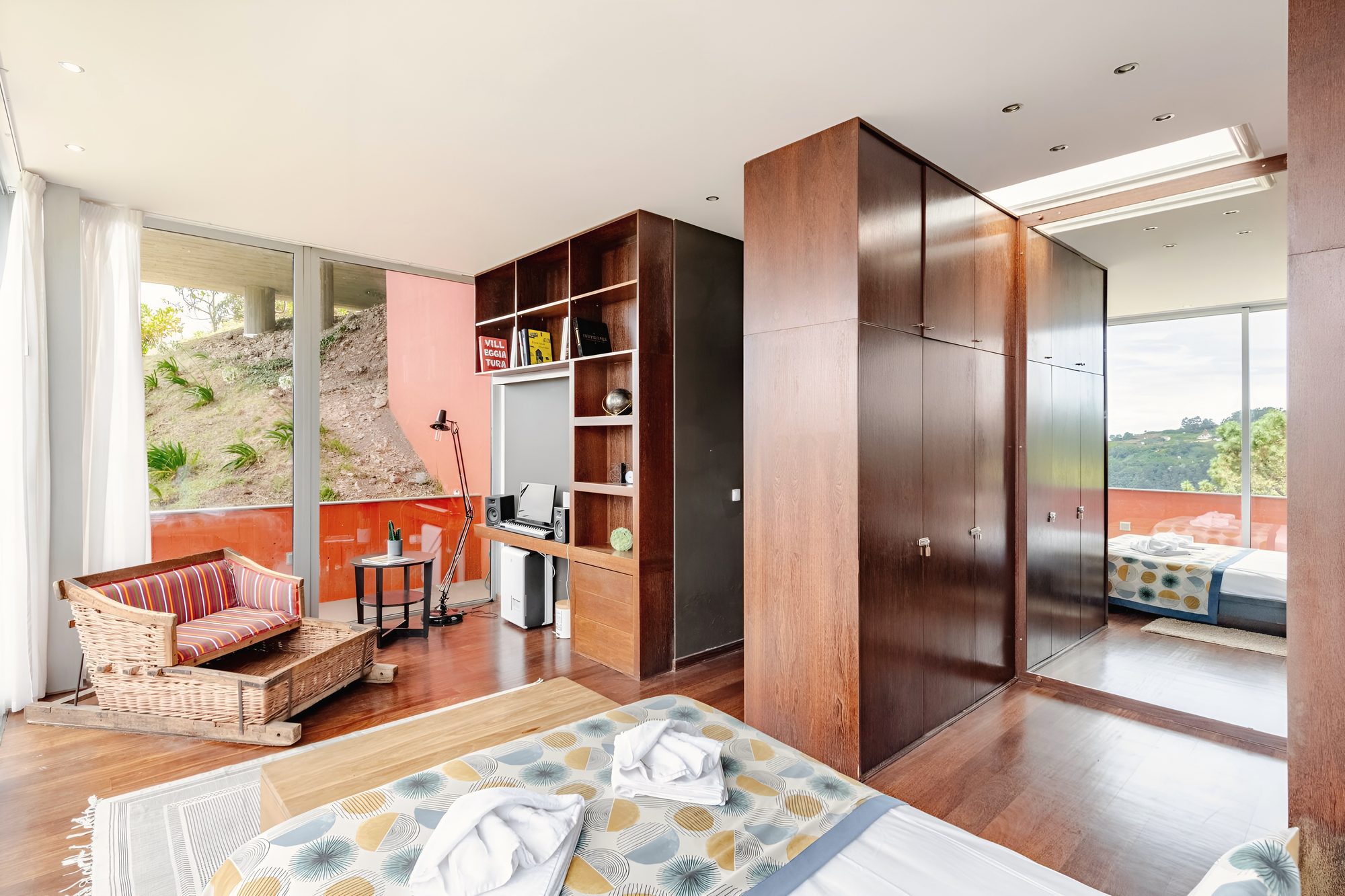 The master suite, the desk and bookshelves beside the glass
