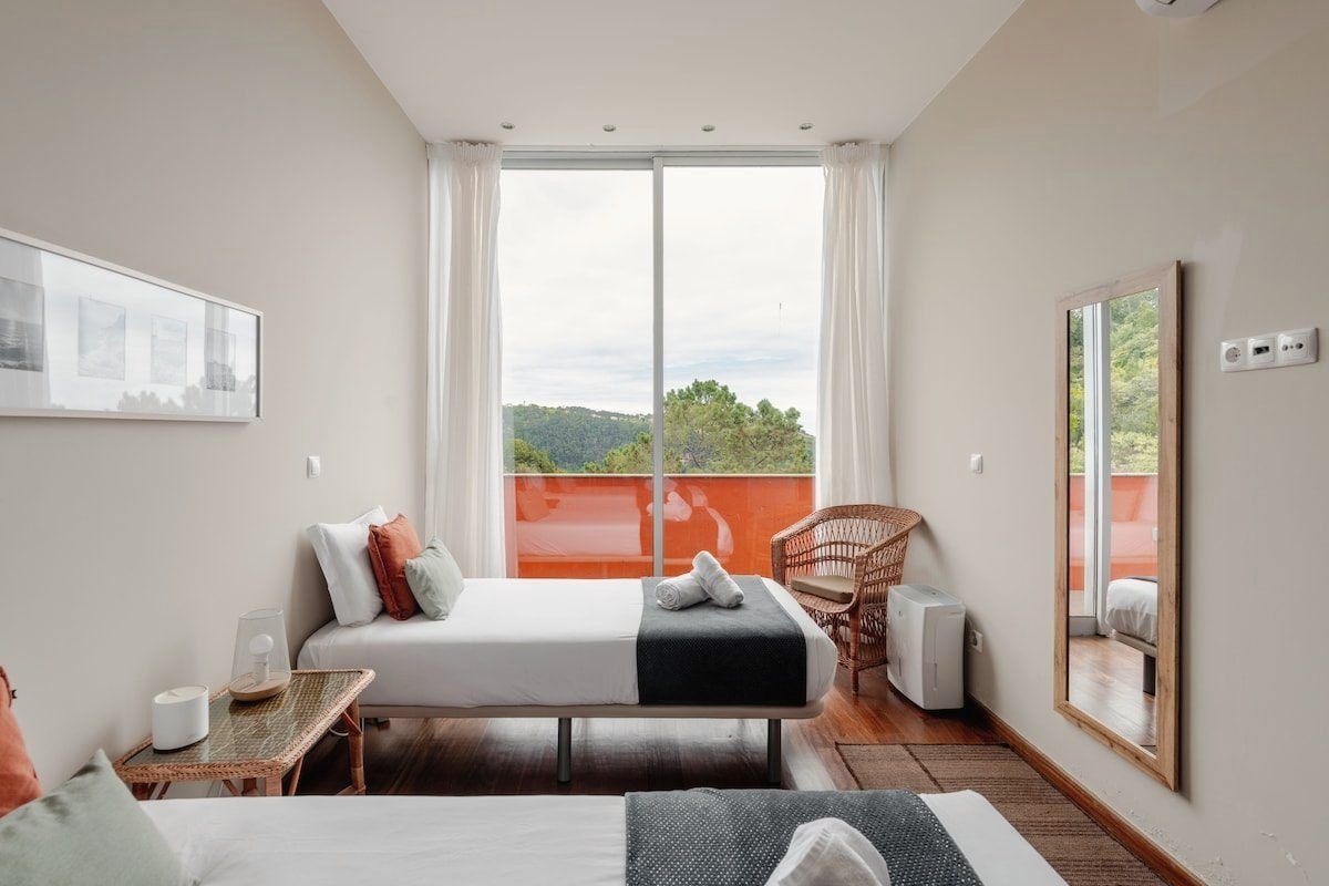 Twin bedroom with two single beds facing the window