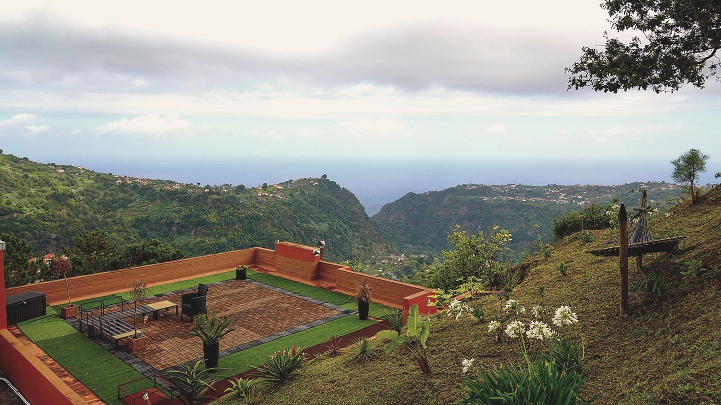 The rooftop terrace and firepit, the valley running to the sea