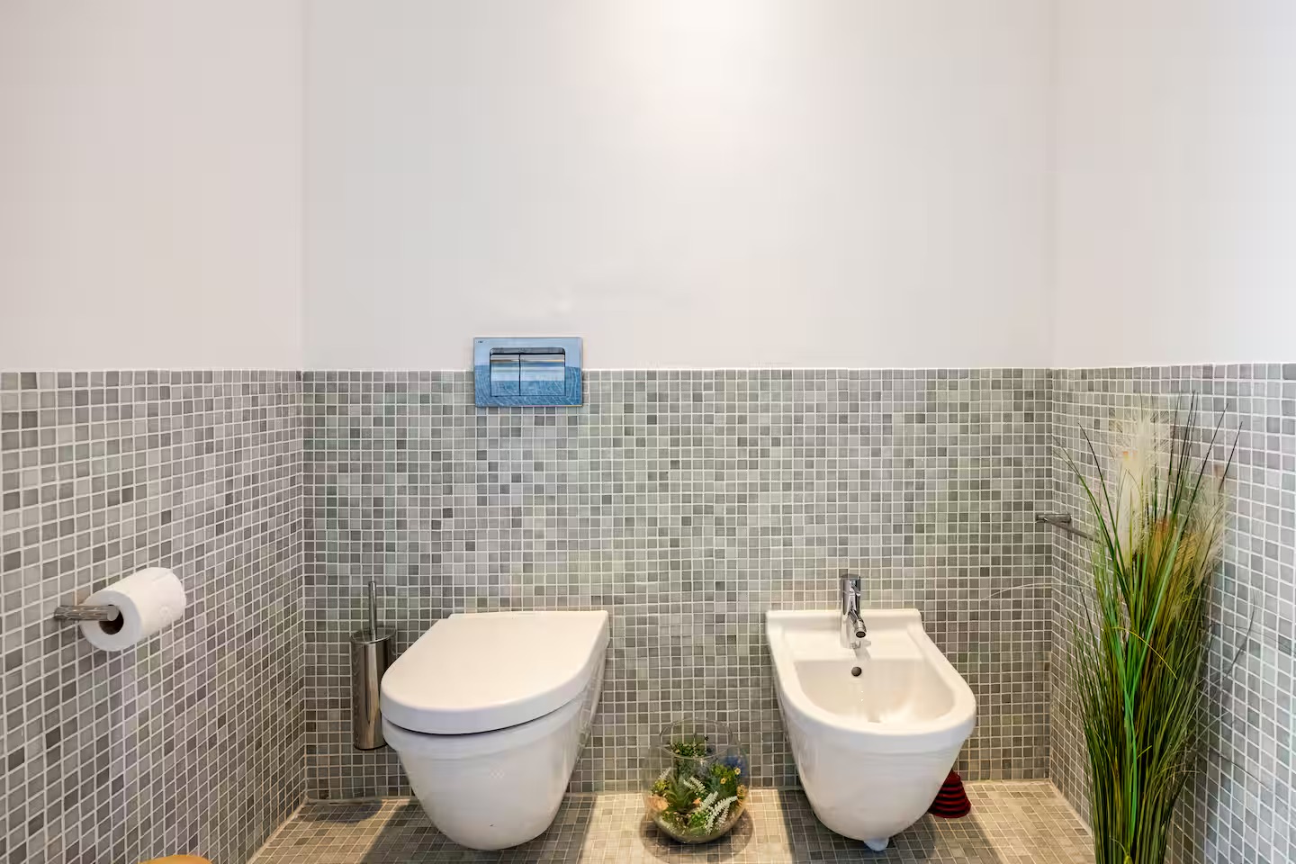 Bathroom with mosaic tile, toilet and bidet