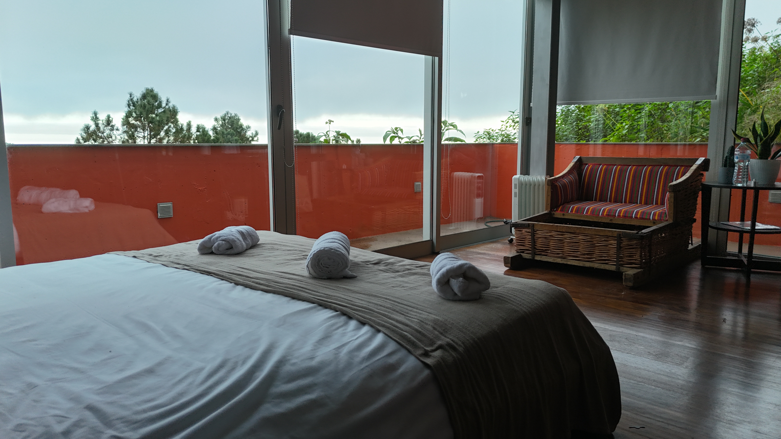 Master bedroom looking out to the orange terrace and trees