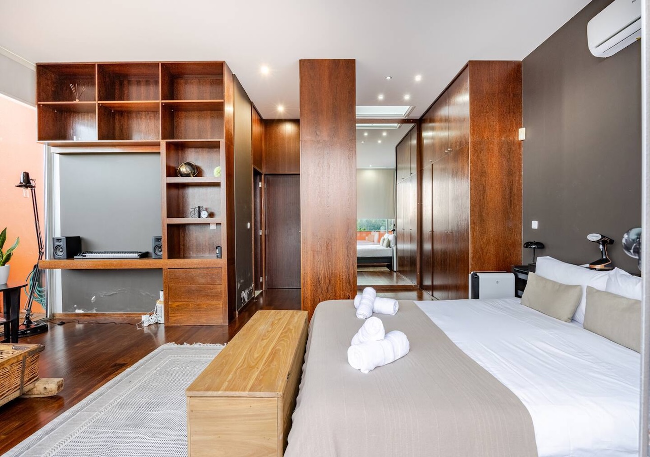 Master bedroom with built-in desk and dark wood cabinetry
