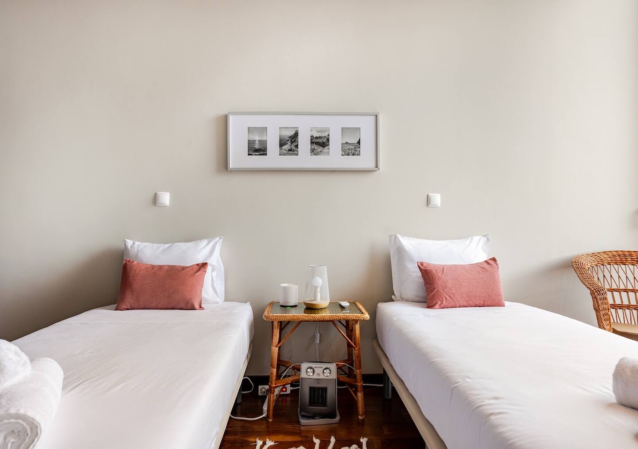 Twin beds with a wicker nightstand between them