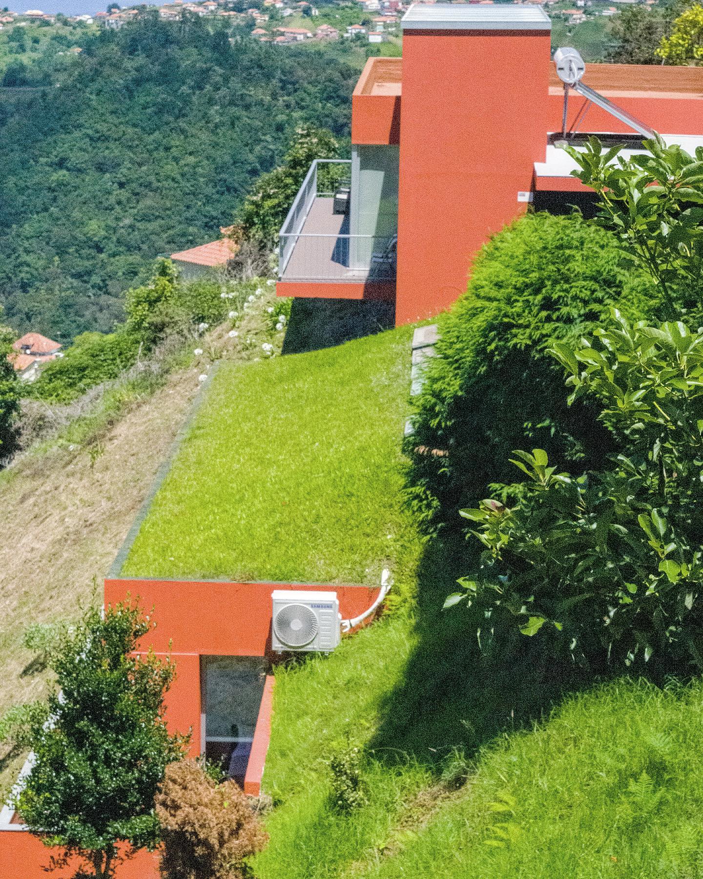 The orange hillside villa from above, stepping down the Santana slope